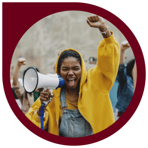 a Black person yelling into a megaphone & holding a fist above their head; outlined in a maroon bubble
